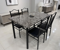 Dining table set with marble-like top and black chairs in a modern room.