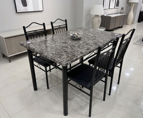 Dining table set with marble-like top and black chairs in a modern room.