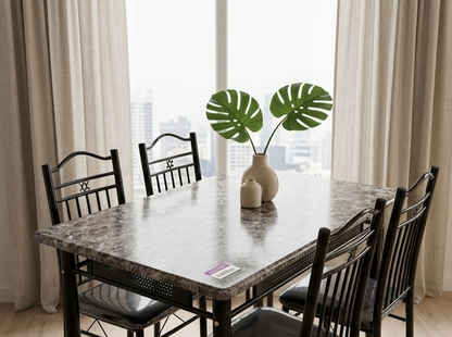 Dining room with a table and chairs near a large window with curtains.