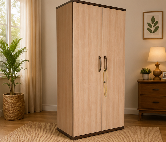 A tall two-door wardrobe with a light wood grain finish and dark trim, standing in a styled bedroom setting next to a window, curtain, potted plant, and wooden nightstand with a lamp.