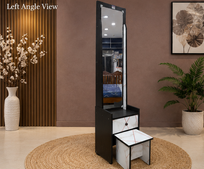 Tall black and white vanity mirror with stool in a room setting with decor elements.