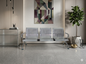 Modern waiting room with metallic chairs, abstract art, and decorative elements.