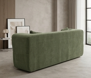 Green sofa in a modern living room with a coffee table and plants.